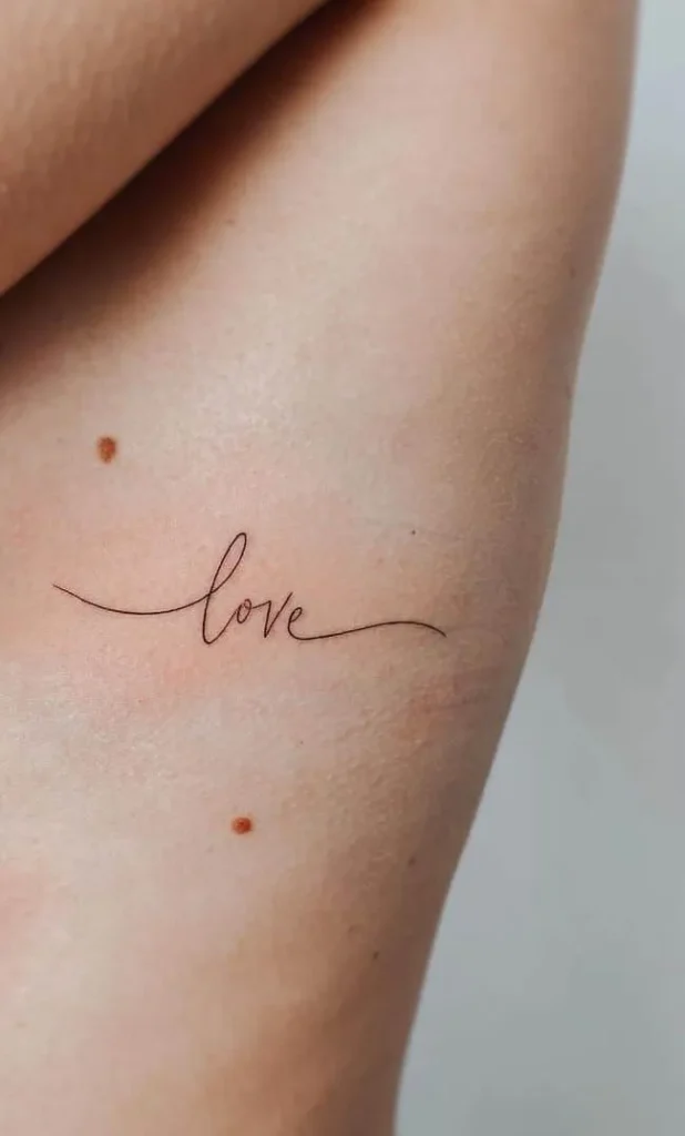 tattoo of “love” on the ribcage