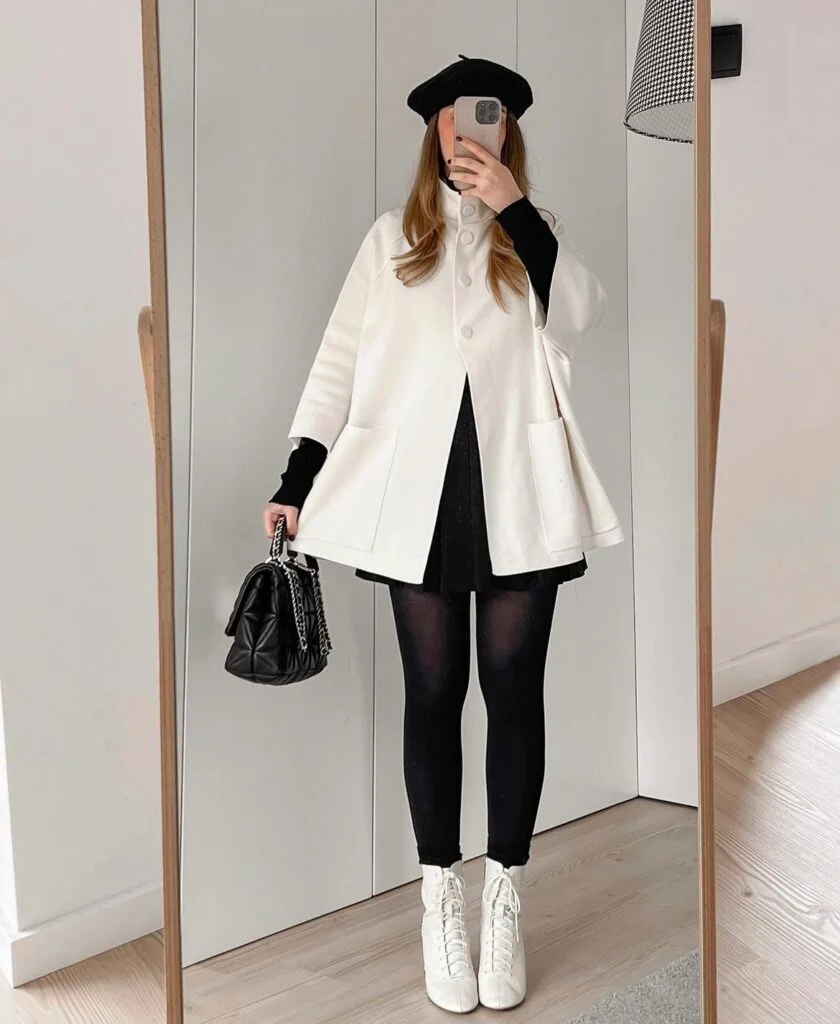 white cape coat with a black skirt