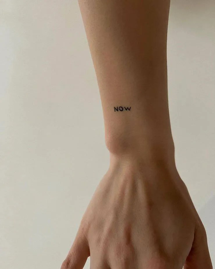 “now” tattoo on the wrist