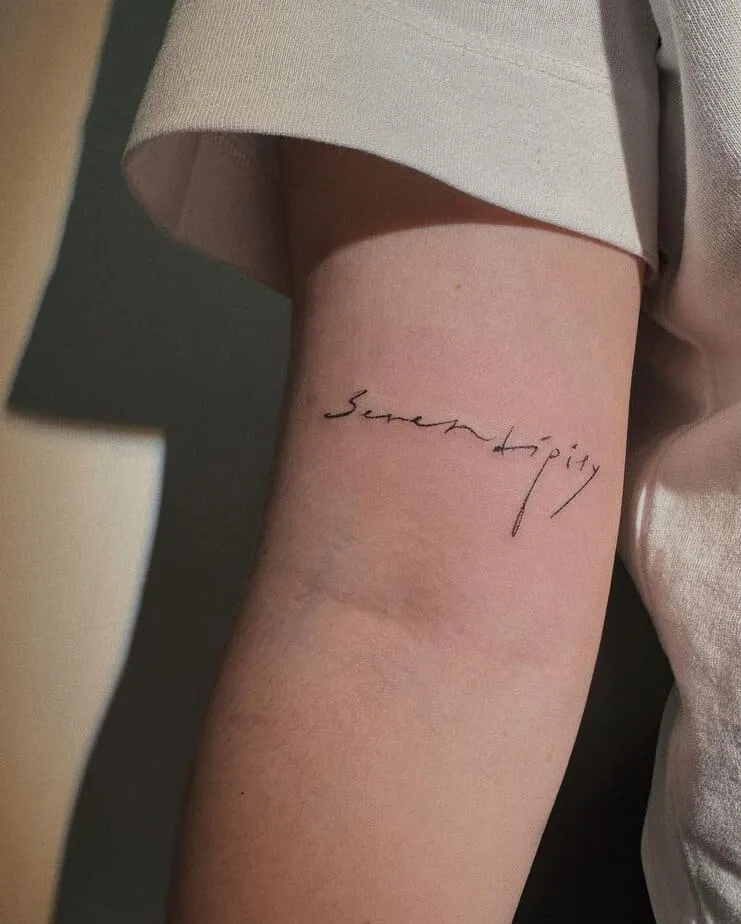  “serendipity” tattoo on the upper arm